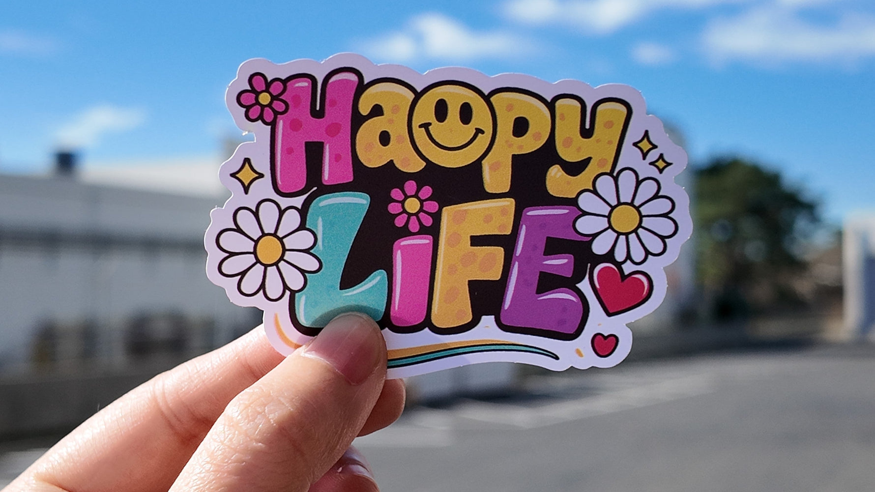 Hand holding a custom die cut sticker for a guide about ordering custom stickers with no minimum.