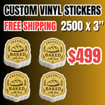 Promotional banner for 2500 custom vinyl stickers (3") for $499 with free shipping. The image displays four stacks of die cut vinyl stickers featuring a vintage-style "FRESHLY BAKED with love" bakery logo with a bread illustration. These high-quality waterproof business decals, perfect choice for personalized bakery packaging, durable product labels, and custom logo deca