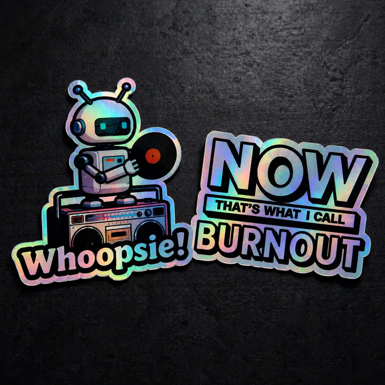 Holographic robot sticker with 'Whoopsie!' and 'Now That's What I Call Burnout' text on a dark background