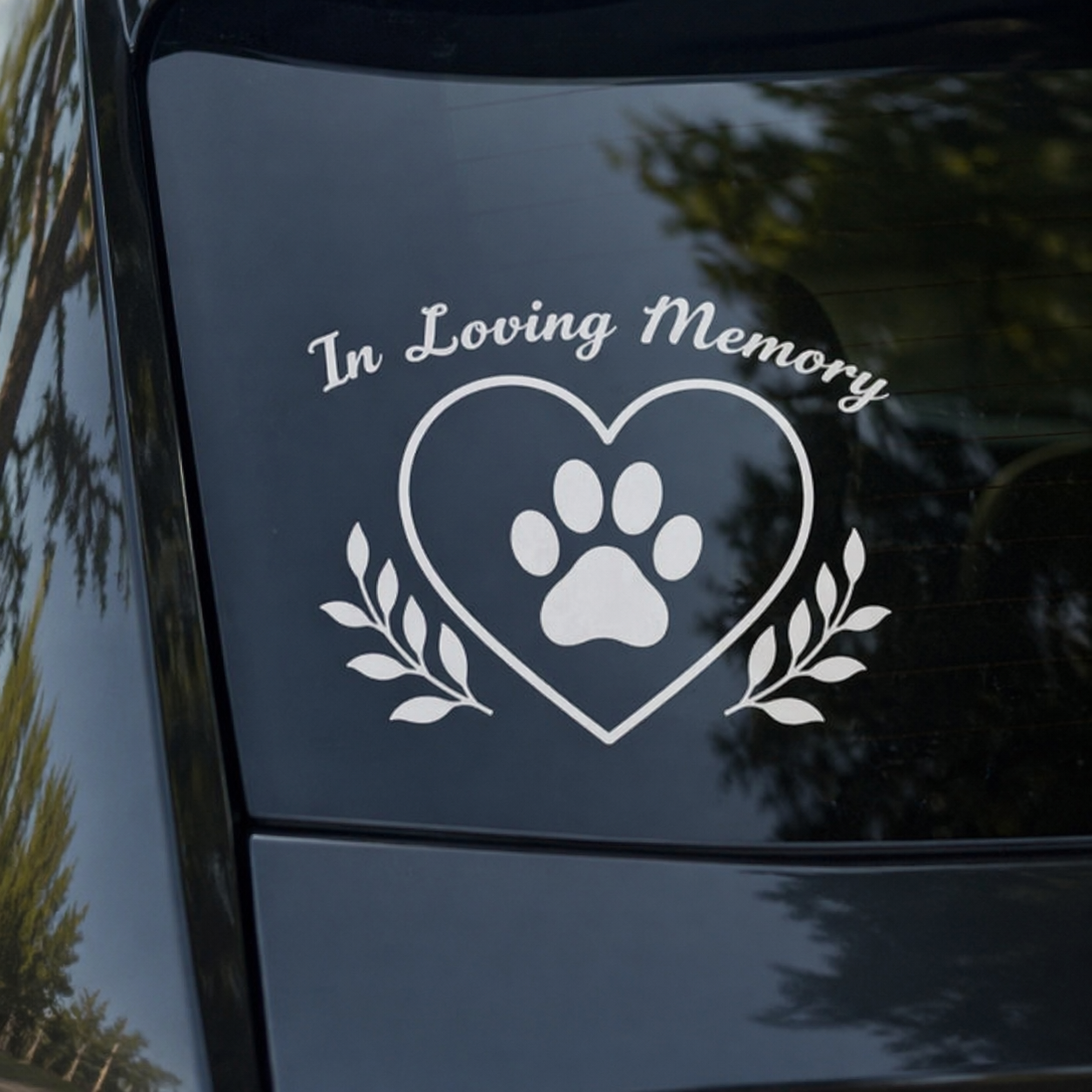 Decal with 'In Loving Memory' and paw print on a car window