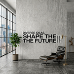 Inspirational vinyl wall graphics saying "Shape the Future" on a grey industrial concrete wall in a professional office.