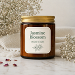 Candle jar labeled “Jasmine Blossom” with a gold lid, styled on a marble surface with dried flowers for professional branding.