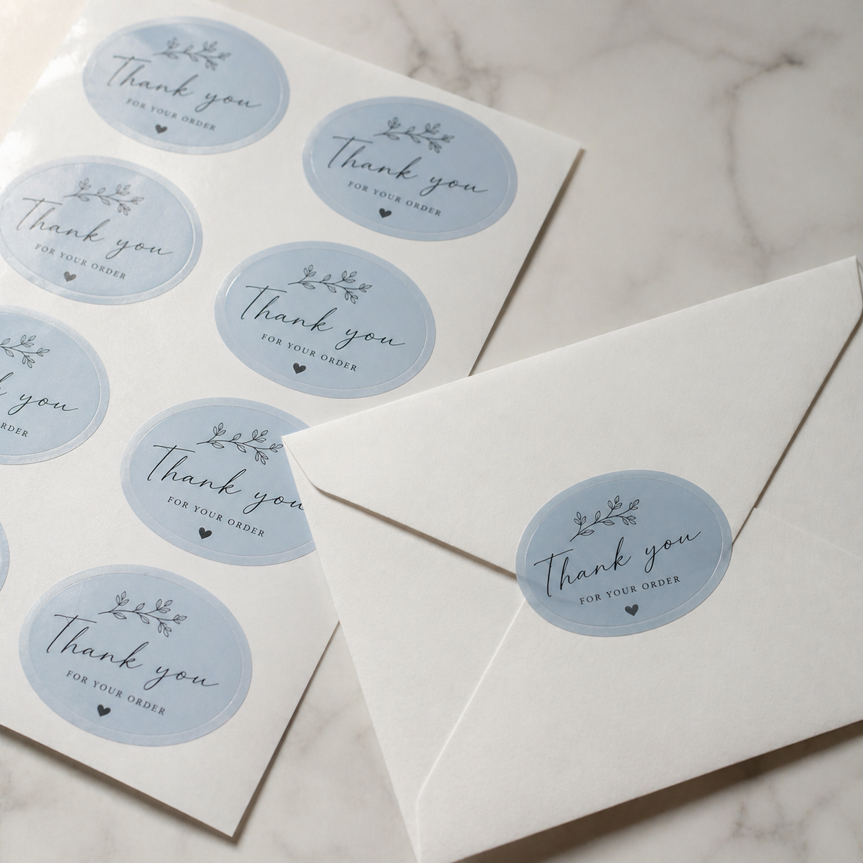 Light blue oval sheet labels for thank-you envelopes, featuring custom printed stickers used as elegant envelope seals
