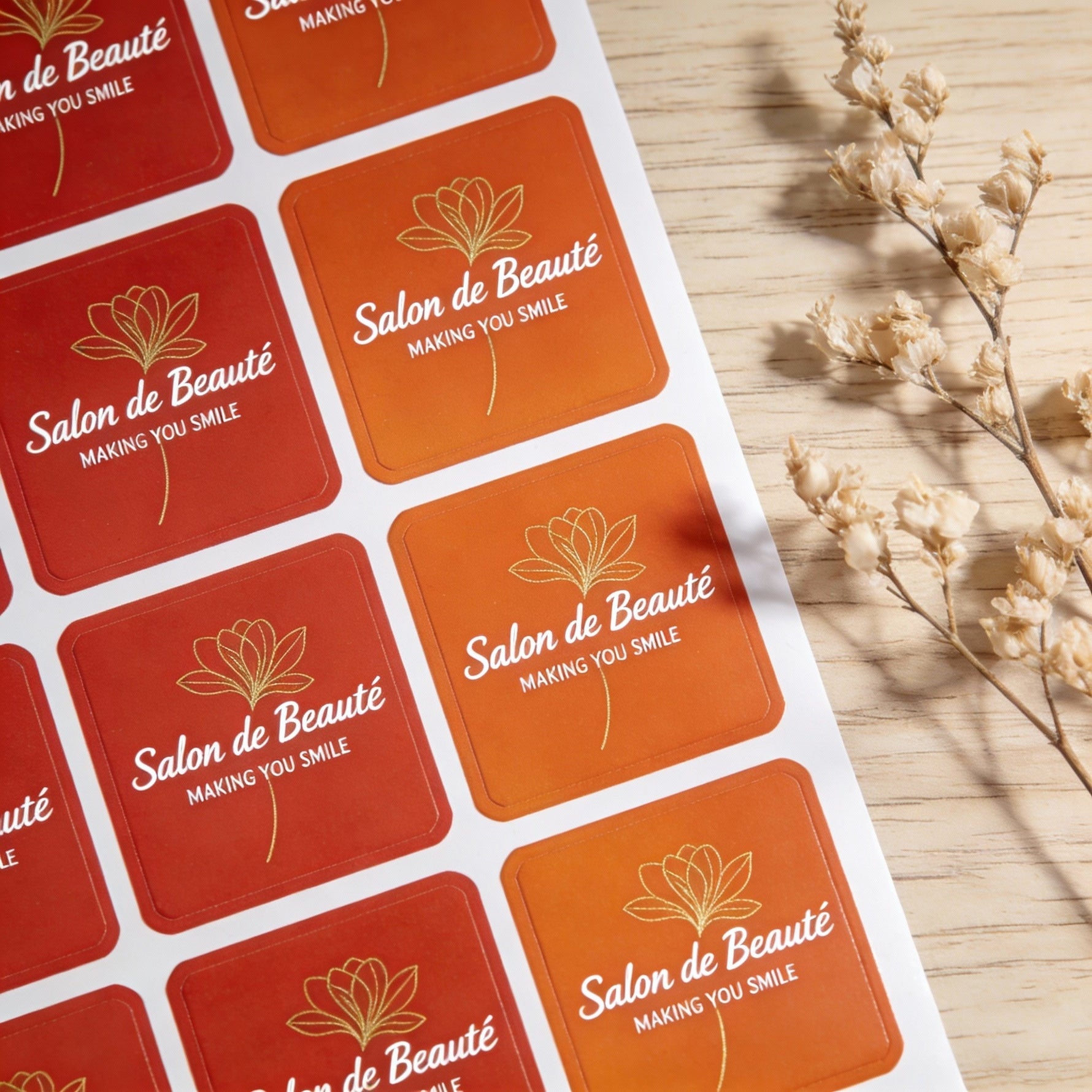 Orange rounded corner sheet labels for salon branding, custom printed beauty stickers arranged on label sheets