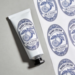 Oval sheet labels for hand cream packaging, featuring blue botanical Lime and Seasalt stickers on a cosmetic tube and label sheet