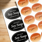 Oval sheet labels for handmade soap packaging, featuring black vegan Soy Soap stickers and orange Paullia Jour brand labels printed on sheets