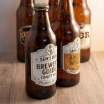 Beer bottles with custom craft brewery labels featuring vintage style branding and product packaging design