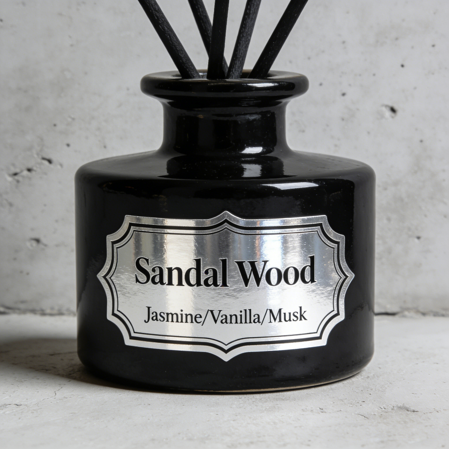 Black diffuser bottle labeled “Sandal Wood” with a metallic silver sticker for a clean, minimal look