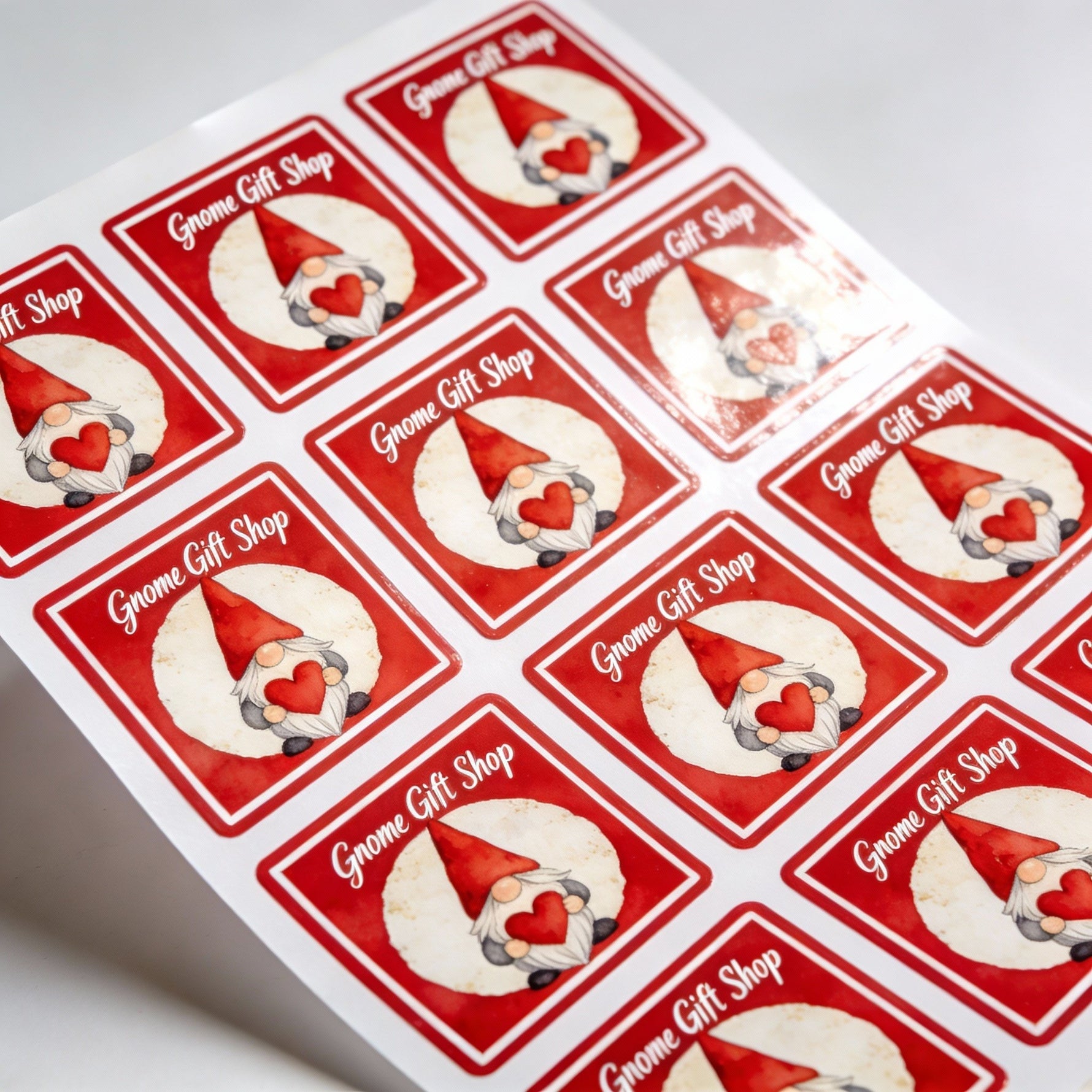 Sheet of square labels with gnome design and 'Gnome Gift Shop' text on a white background