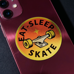 Phone case with 'Eat Sleep Skate' shiny stickers on a dark background