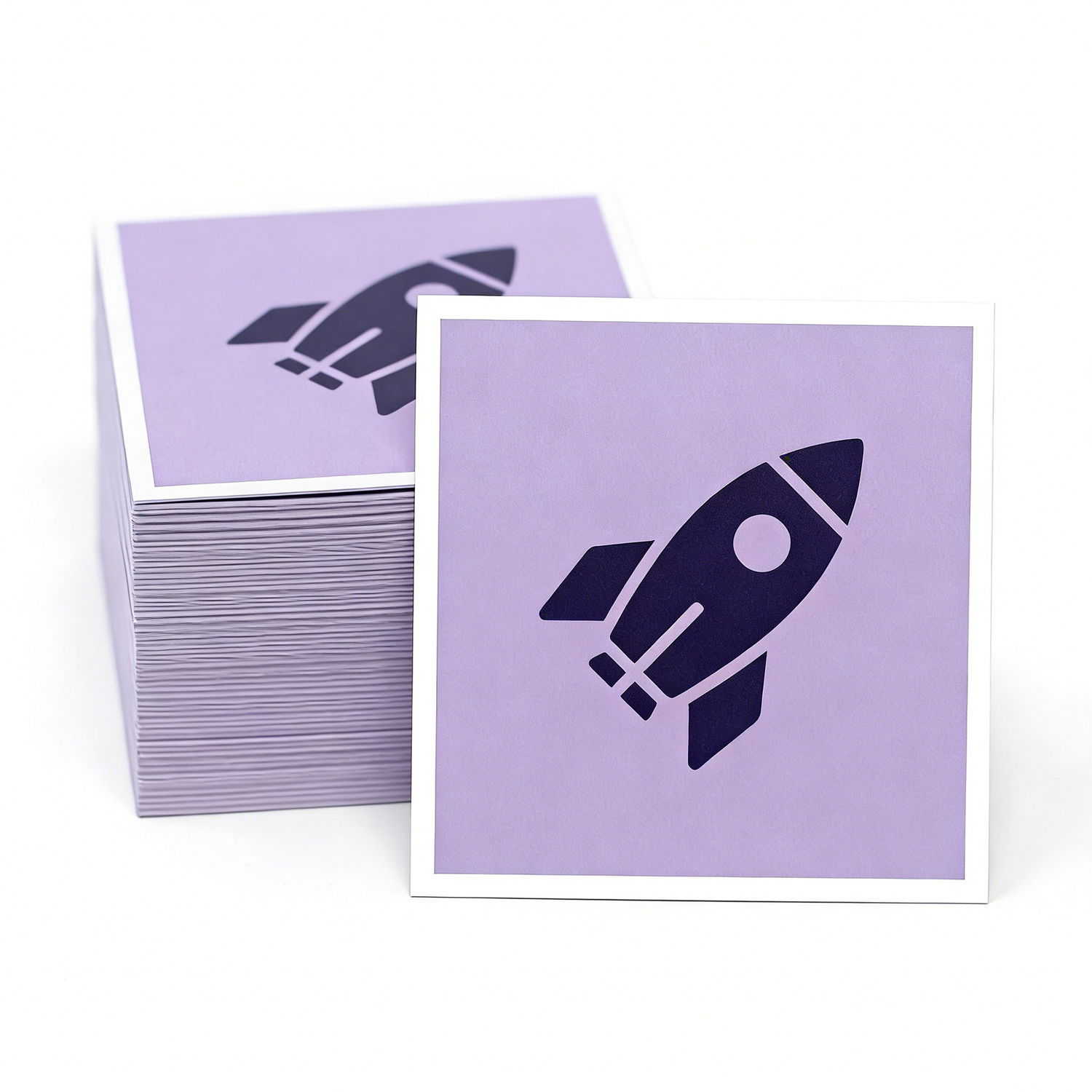 Stack of Purple square stickers with rocket ship design on a white background