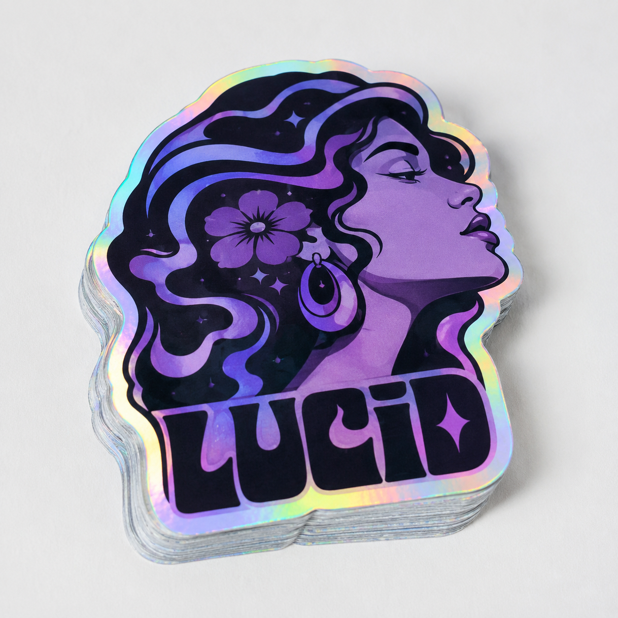 Custom holographic stickers with an artistic purple profile design, glossy rainbow shimmer, die-cut edges, and premium stacked sticker texture.