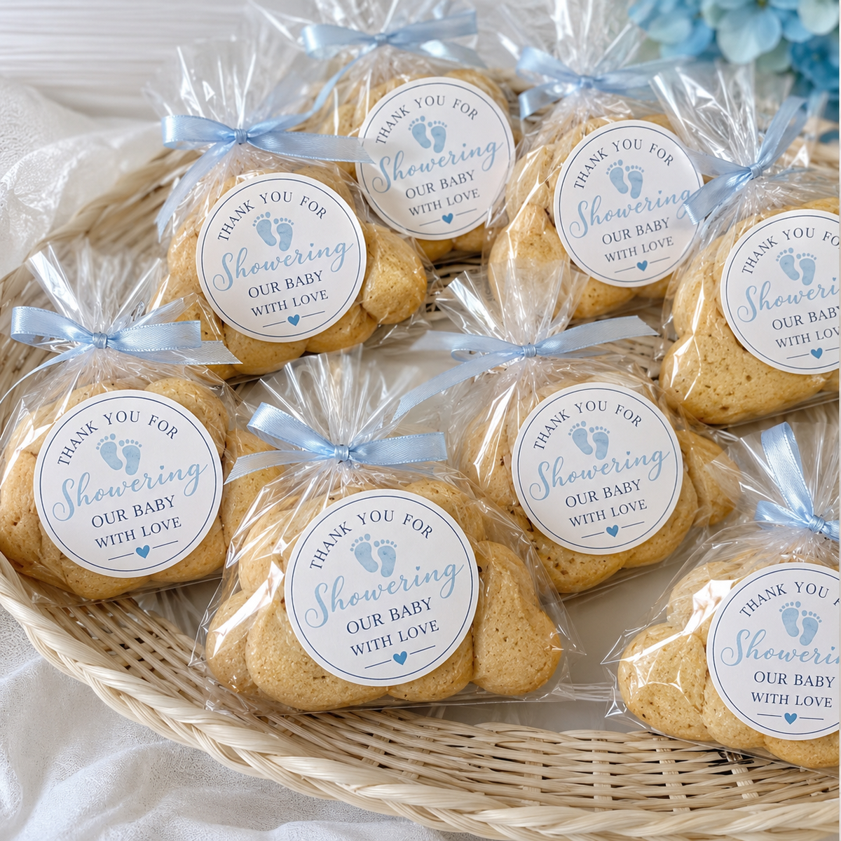 Baby shower favor stickers placed on cookie bags for personalized party treats