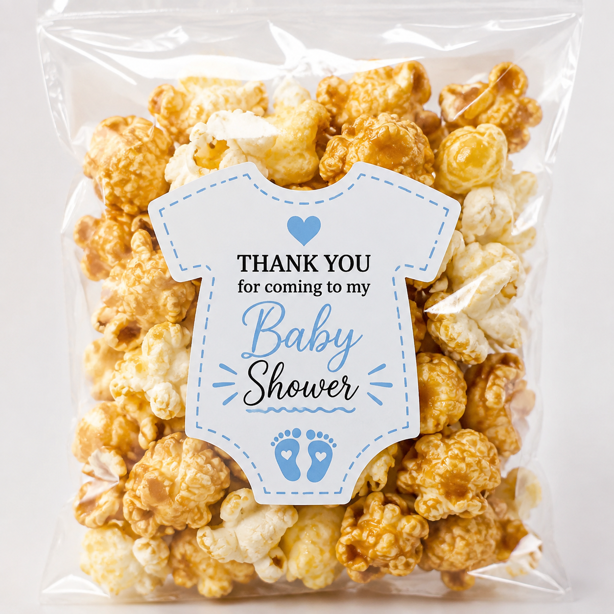 Baby shower sticker on a popcorn favor bag for personalized party treats