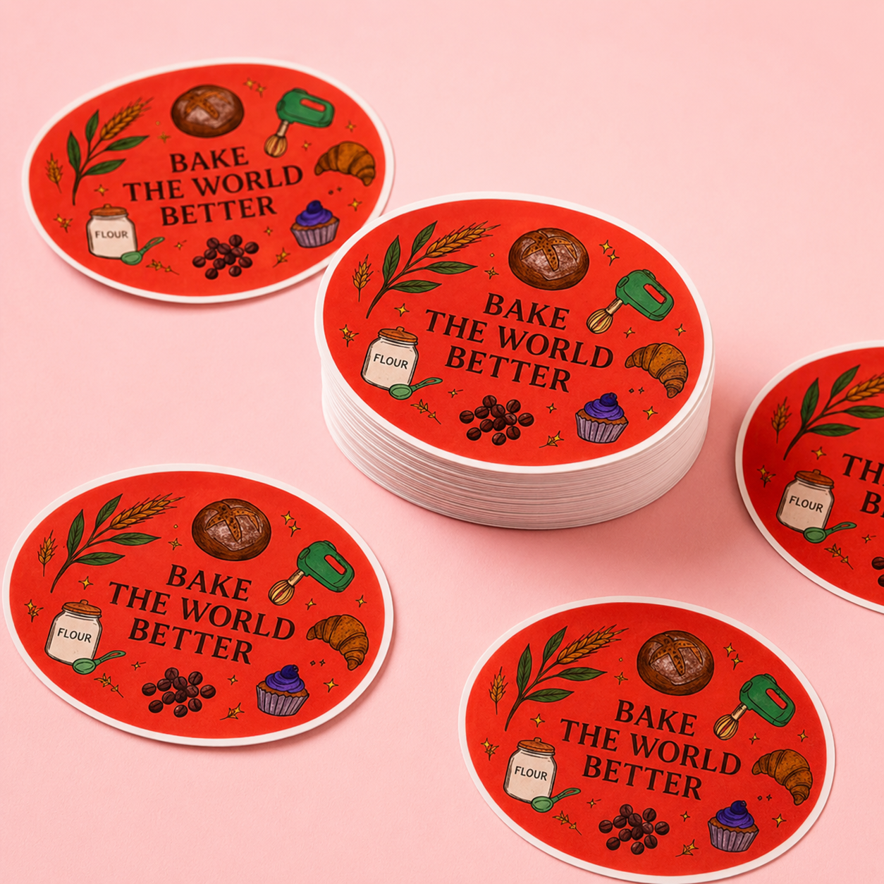 Red coasters with 'Bake the World Better' text and baking-themed illustrations on a pink background.