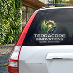 Terracore Innovations logo decal on a car window with a building and greenery in the background