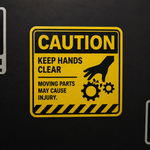 Caution keep hands clear label warning about moving parts and machinery injury risks.