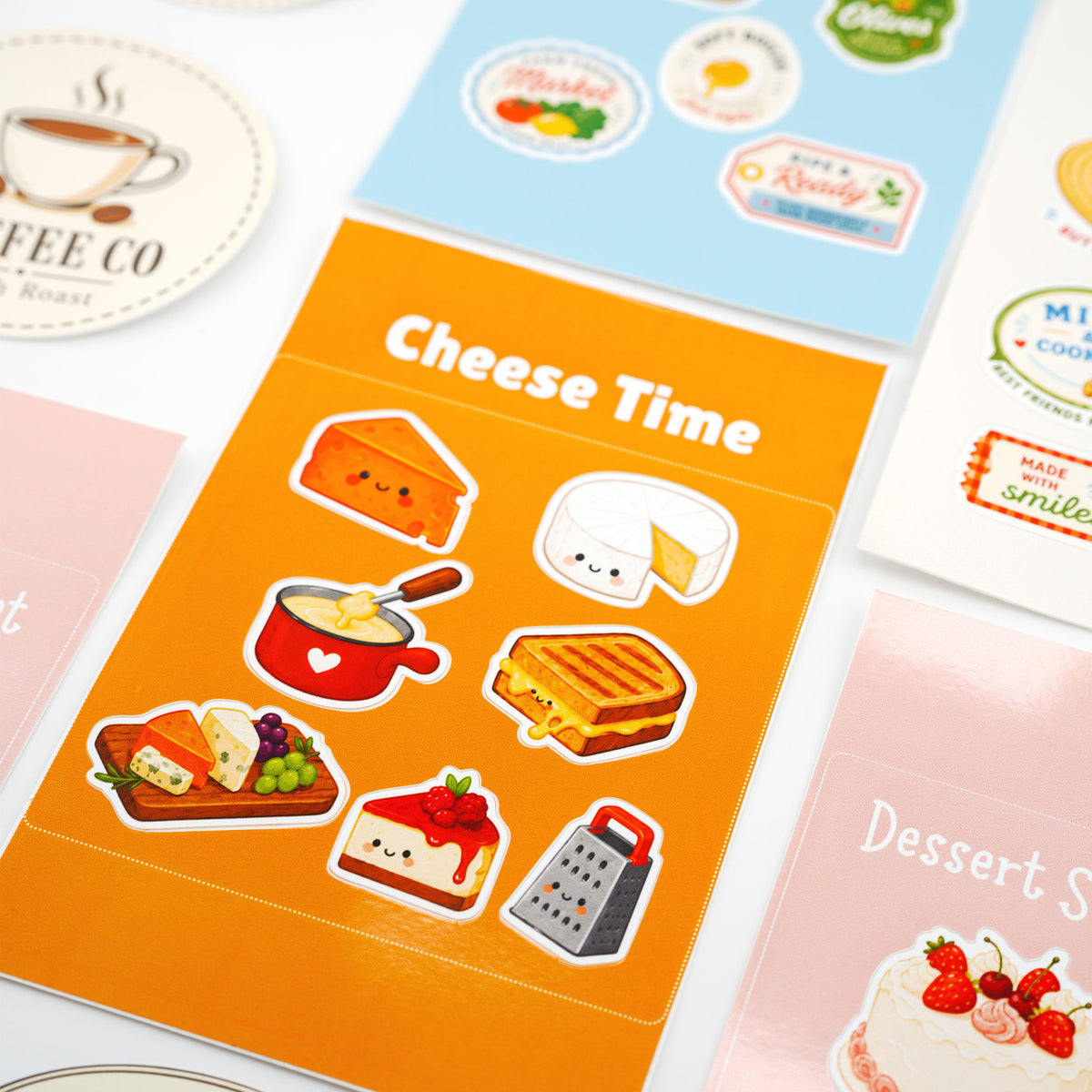 Custom sticker sheets featuring cute cheese and food illustrations on a vibrant orange background sheet.