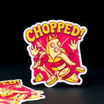 Die-cut vinyl sticker of a cartoon banana man being chopped into slices, vibrant yellow and deep pink design, professional full-volor printing.