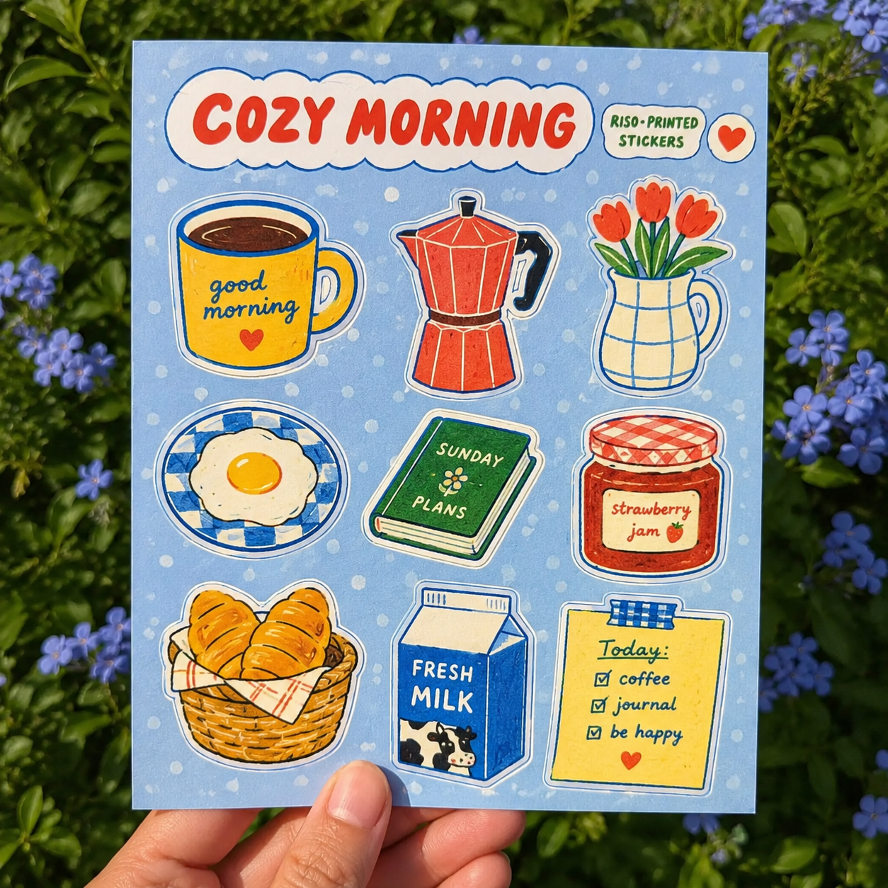 Sticker sheet featuring watercolor illustrations of a coffee cup, moka pot, tulip vase, fried egg, planner, strawberry jam, croissants, milk carton, and a to-do note on a light blue background.