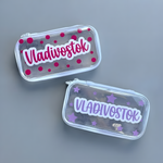 Two colorful personalized name stickers displayed on clear rectangular labels.