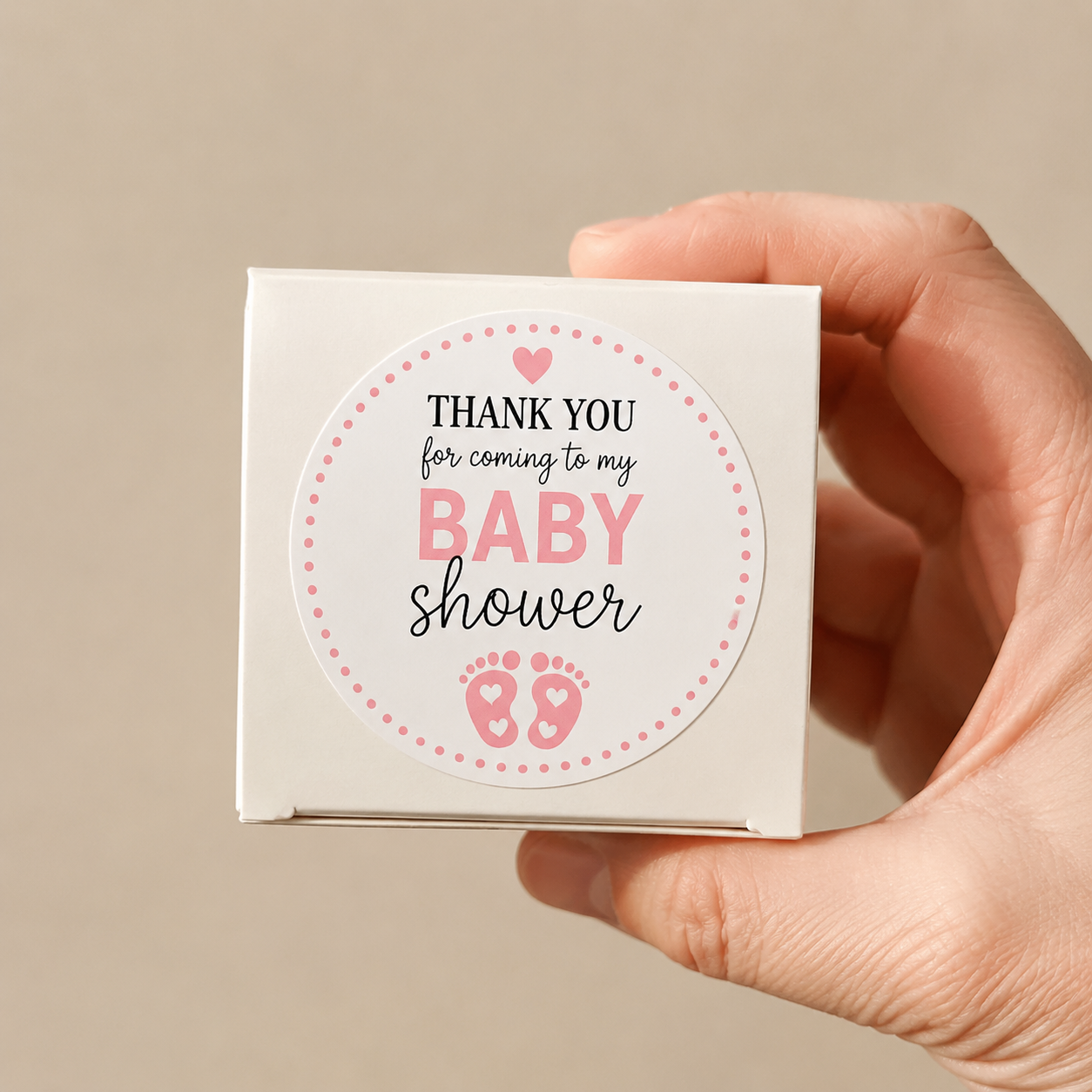 Custom baby shower sticker on a white gift box for party favor packaging