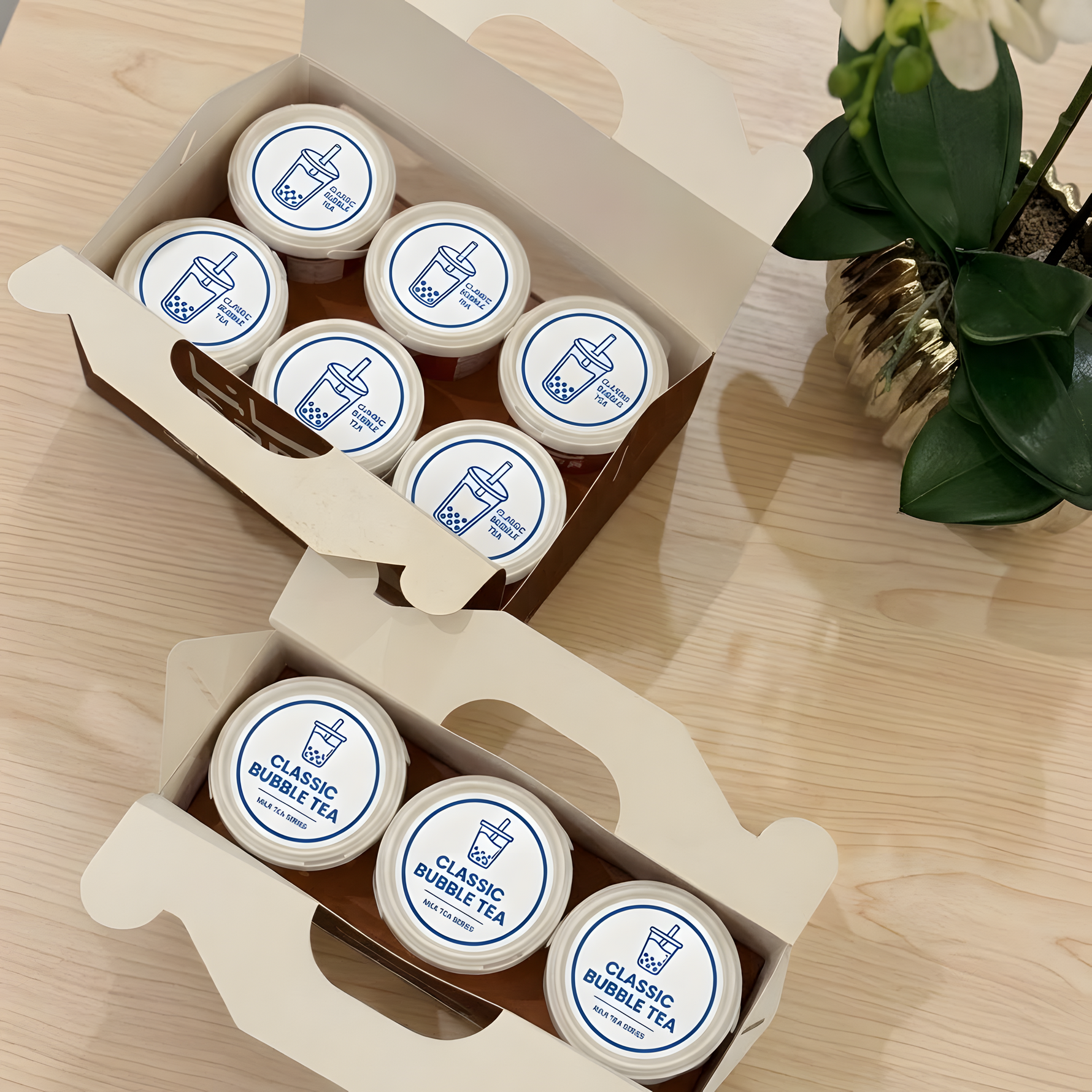 Close-up of clear plastic cups with custom Classic Bubble Tea logo stickers.