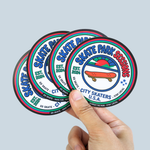 Hand holding four custom circle stickers featuring a colorful skate park logo design.