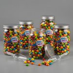 Custom clear labels applied to glass candy jars filled with colorful sweets.