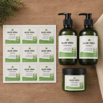 Custom cosmetic labels on white vinyl sheets applied to aloe vera shower gel, shampoo, and body scrub bottles