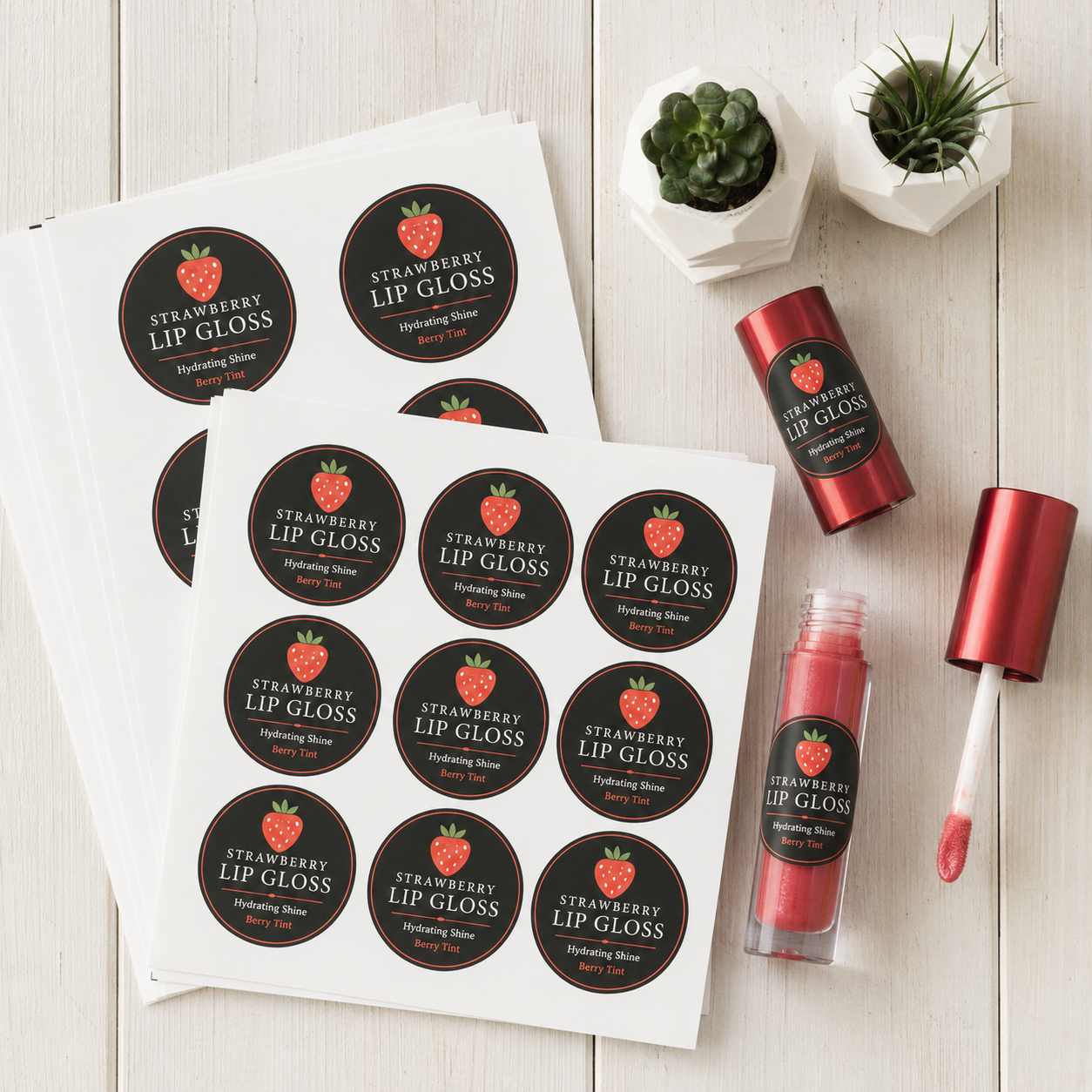 Custom cosmetic labels on white vinyl sheets applied to strawberry lip gloss containers, waterproof and full-color printed