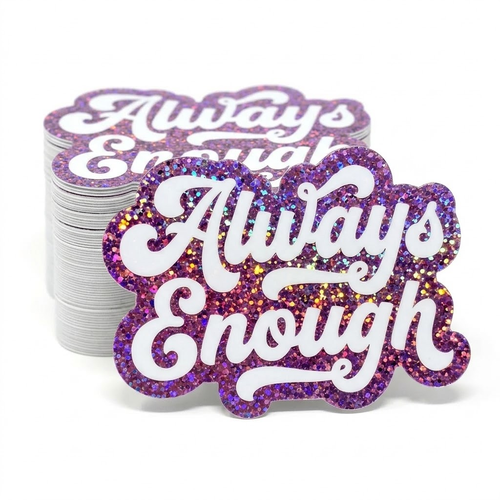 Stack of custom 'Always Enough' glitter stickers with glittery purple design on a white background