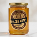 Custom gold foil oval label applied to a glass jar of premium honey.