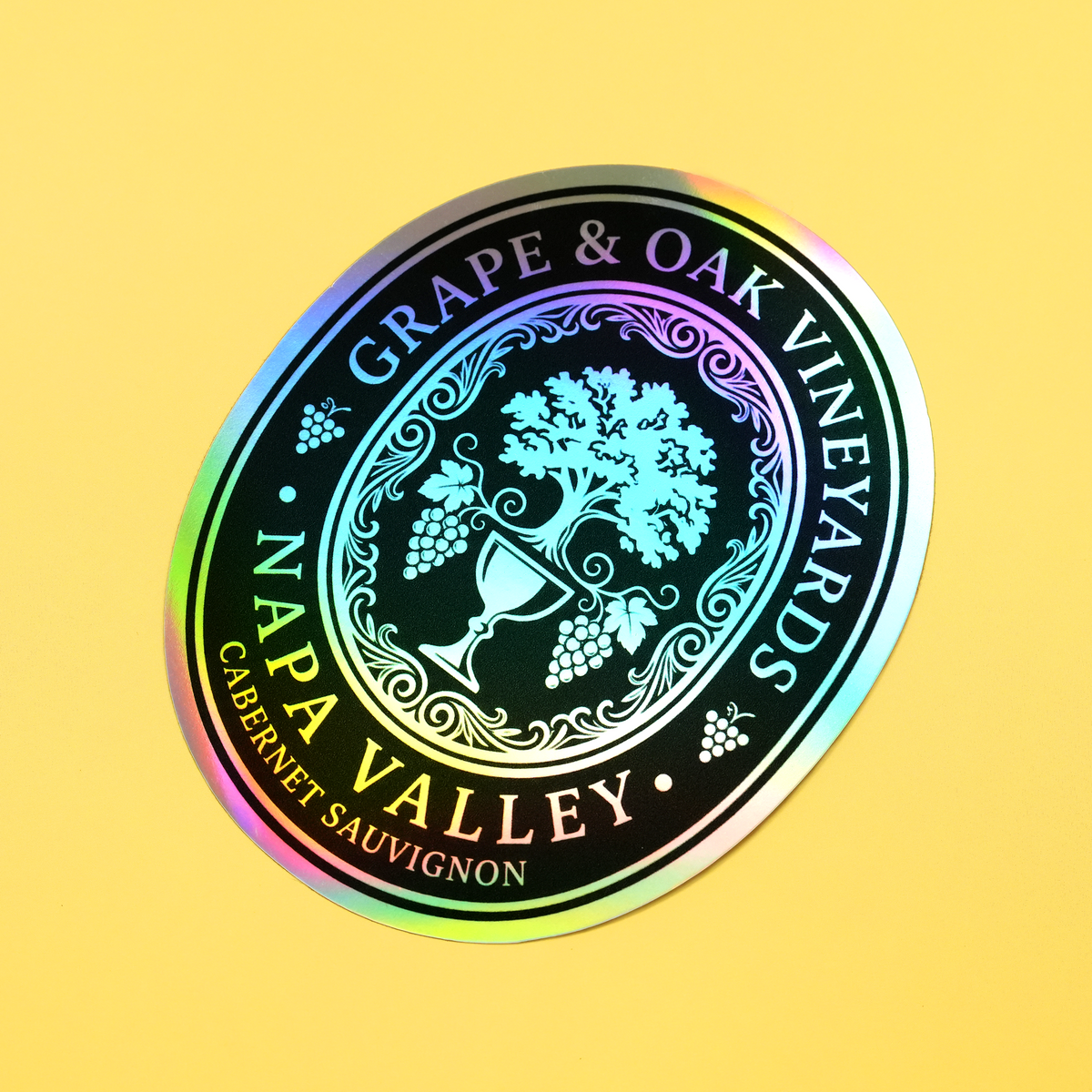 Round custom holographic vineyard sticker with grapevine, wine glass and rainbow reflective finish.