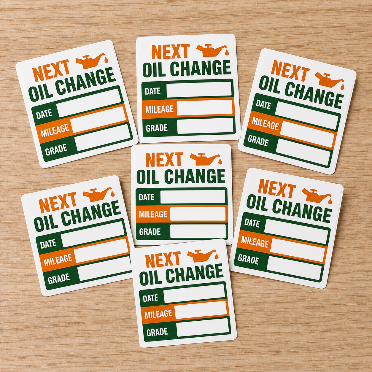 Custom next oil change stickers featuring orange and green design with spaces for date, mileage, and oil grade.