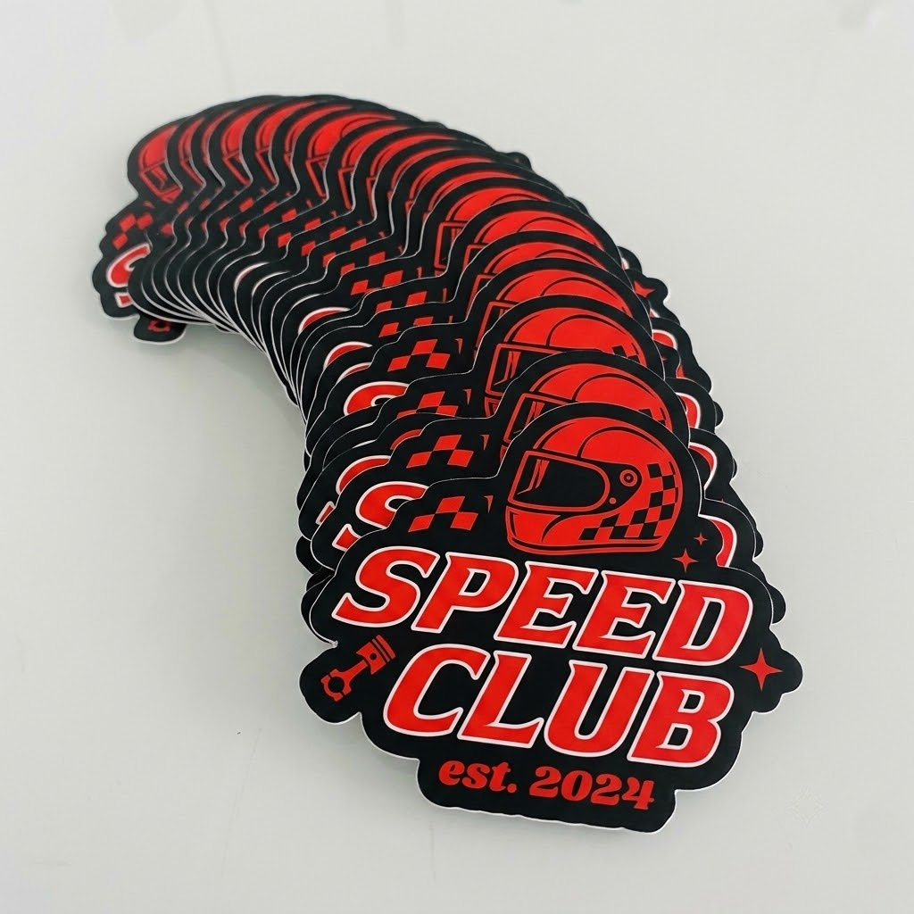 Stack of custom die-cut vinyl stickers showing detailed printing and durable vinyl quality for branding and promotional use.