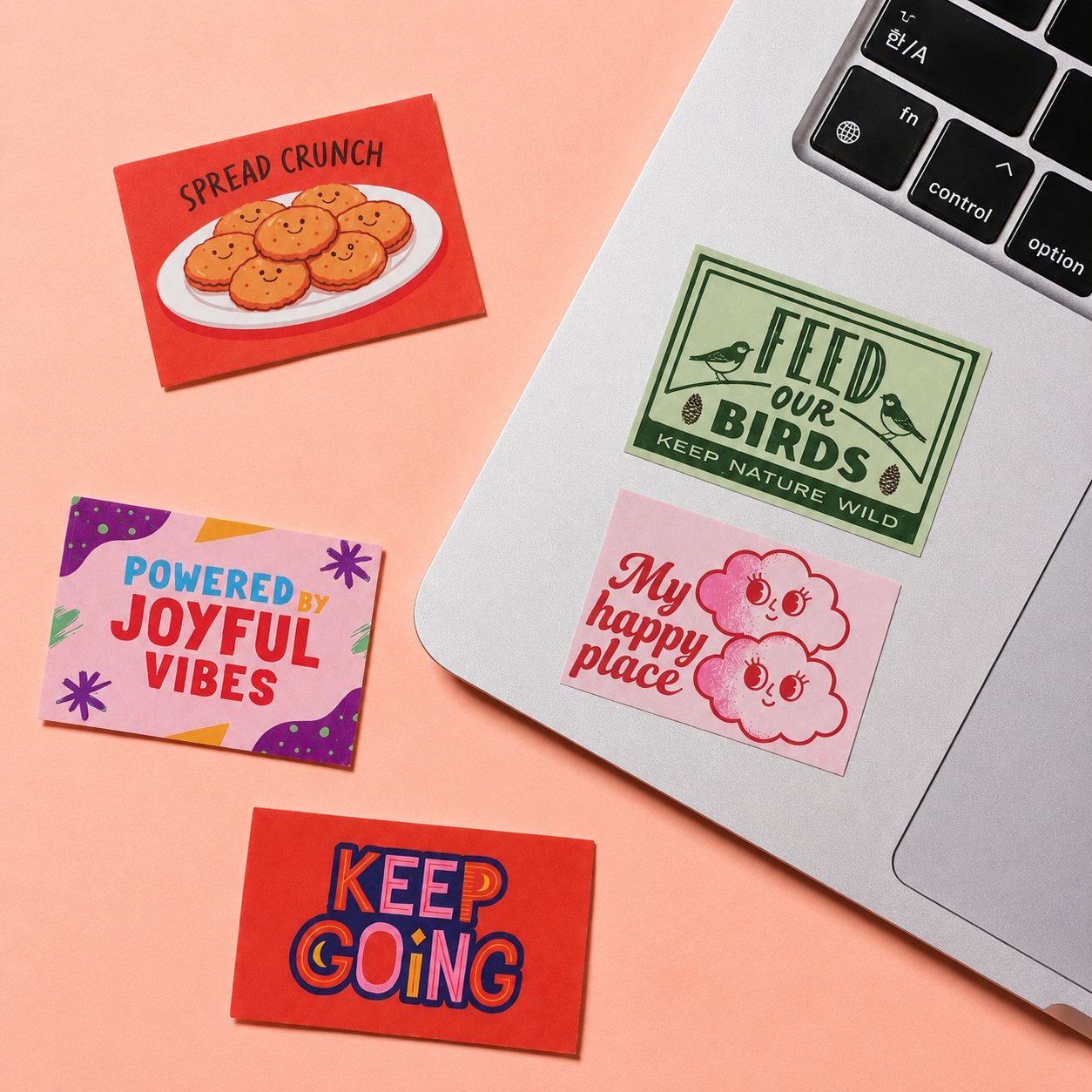 Custom rectangle stickers shown on a laptop and peach background with colorful slogan designs