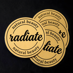 Custom round gold metallic stickers with black natural beauty logo printing.