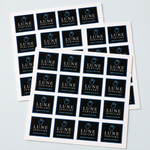 Multiple sheets of black custom square perfume logo labels for premium product packaging.