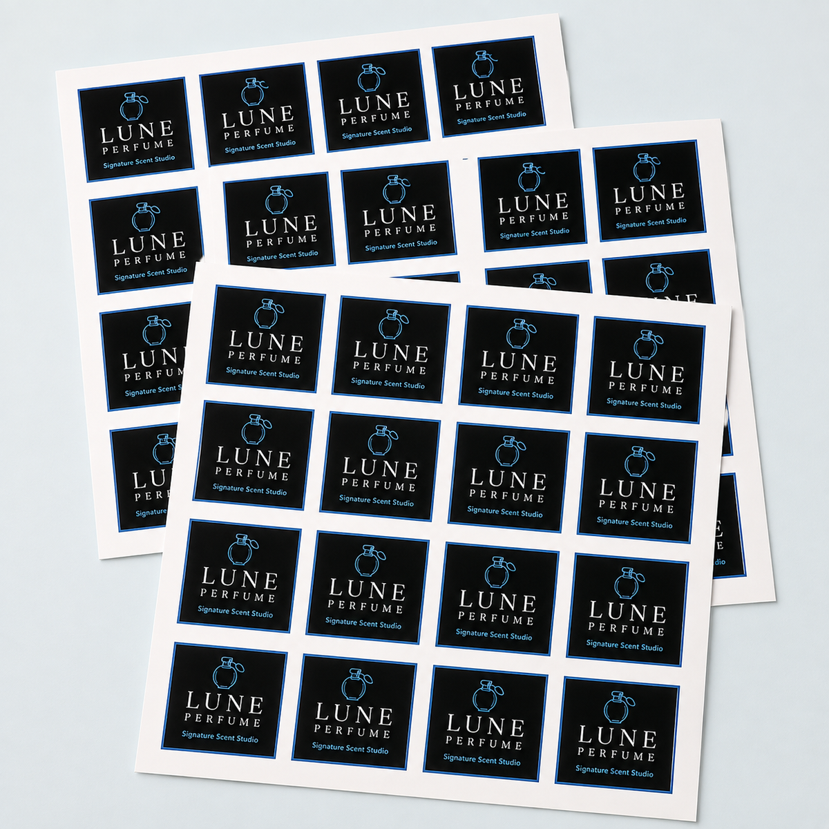 Multiple sheets of black custom square perfume logo labels for premium product packaging.