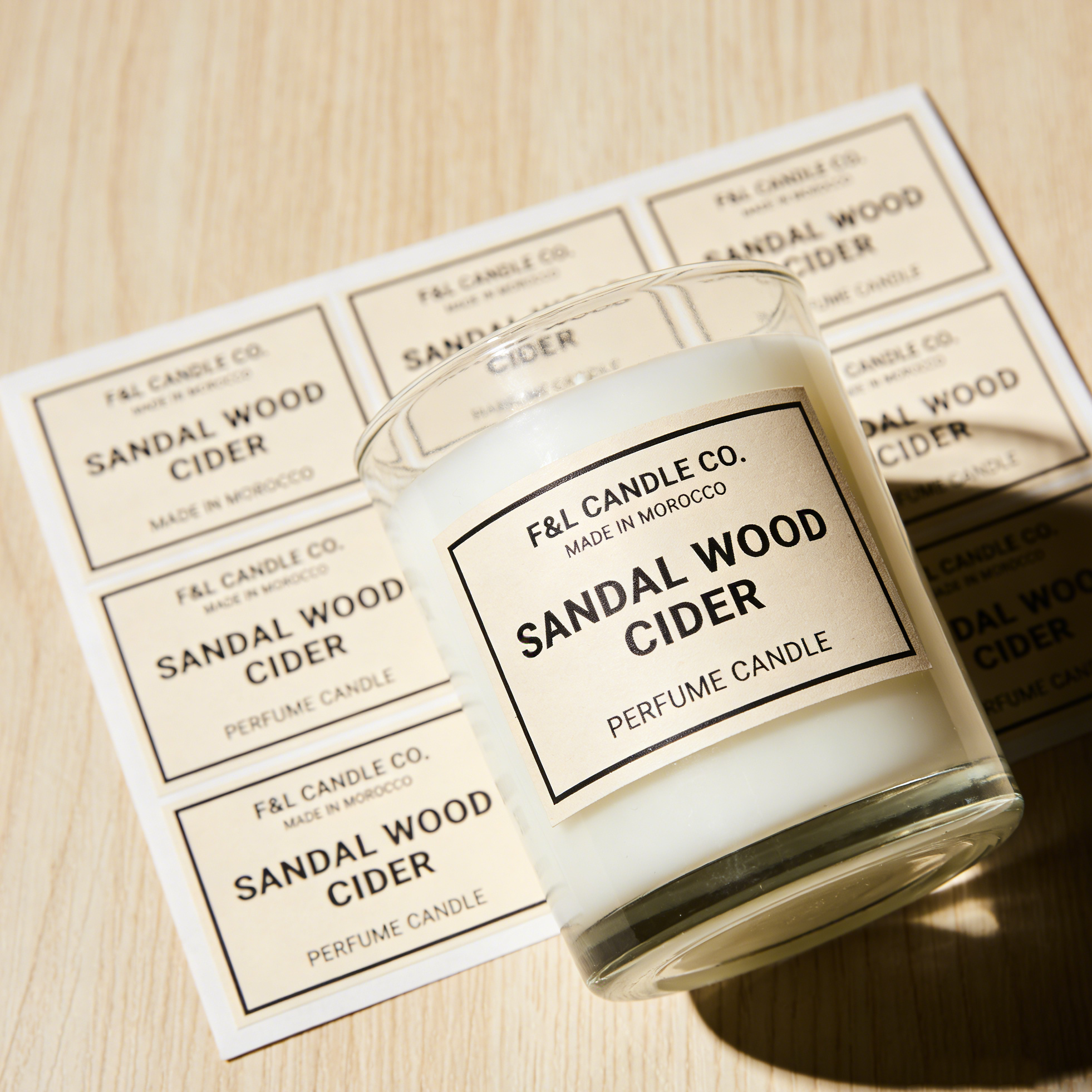 Custom candle label stickers applied on glass jar candle with matching label sheet for perfume candle packaging and branding