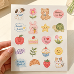 Sticker sheet featuring cute watercolor illustrations of a puppy, teddy bear, bunny, turtle, cat, flowers, fruit, desserts, candy, and positive message stickers on a white background