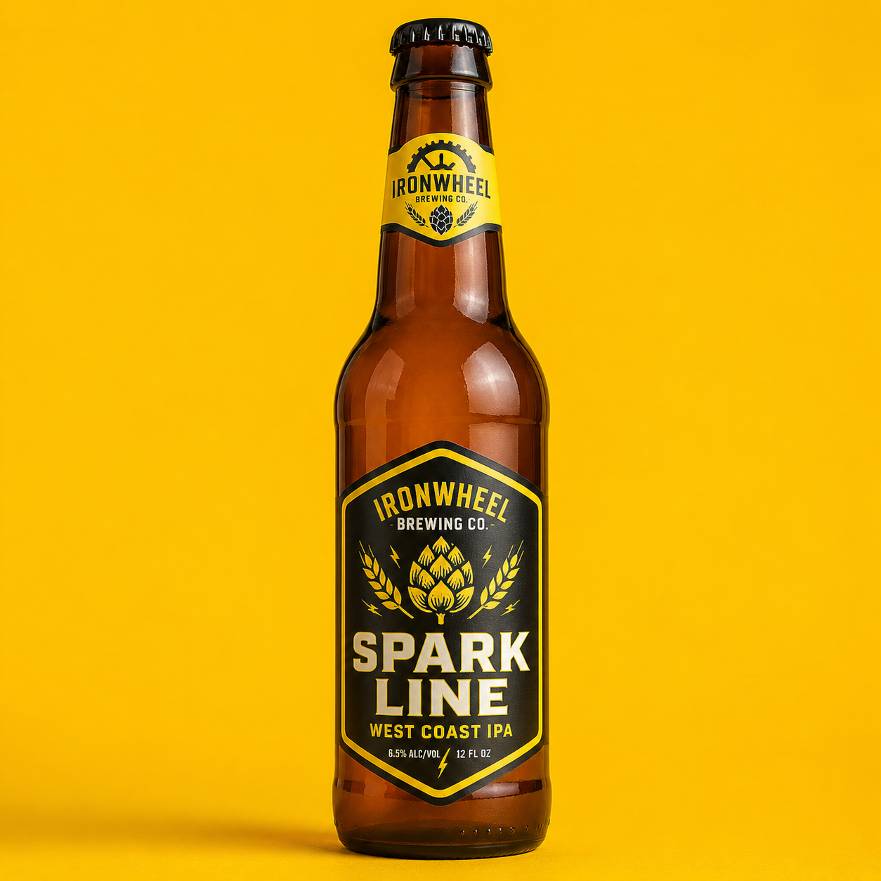 A single brown beer bottle featuring a premium custom black and yellow brewery label for Ironwheel Brewing Co's Spark Line West Coast IPA, isolated on a clean yellow background.