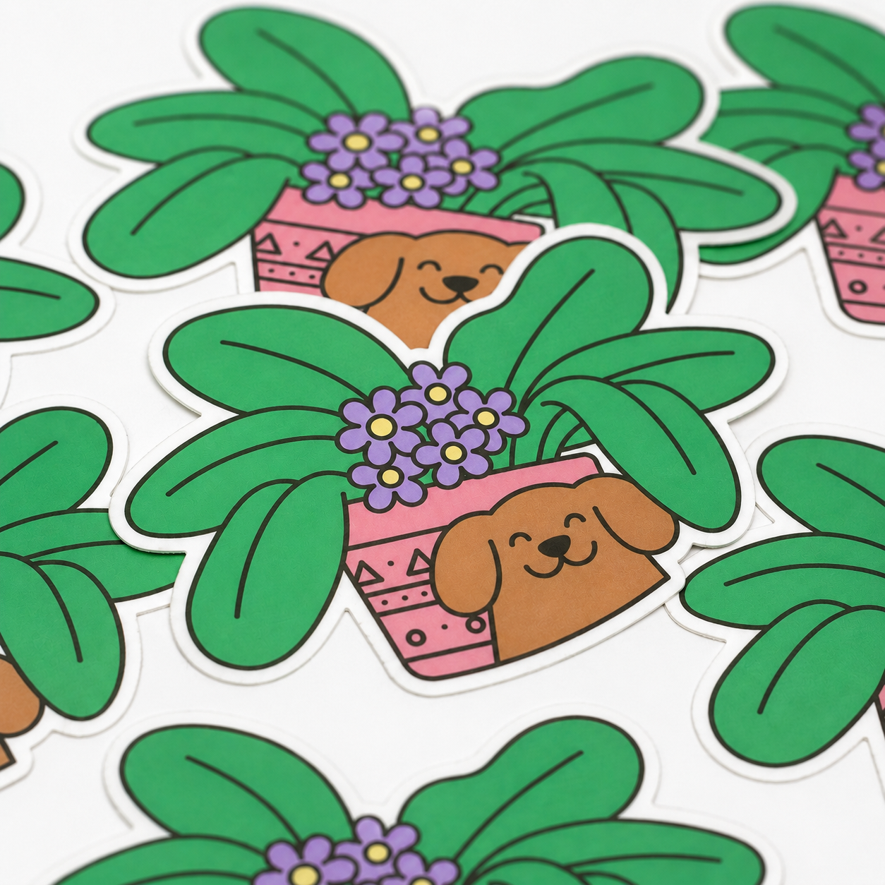 Close up of cute dog and plant die cut artist stickers with white borders
