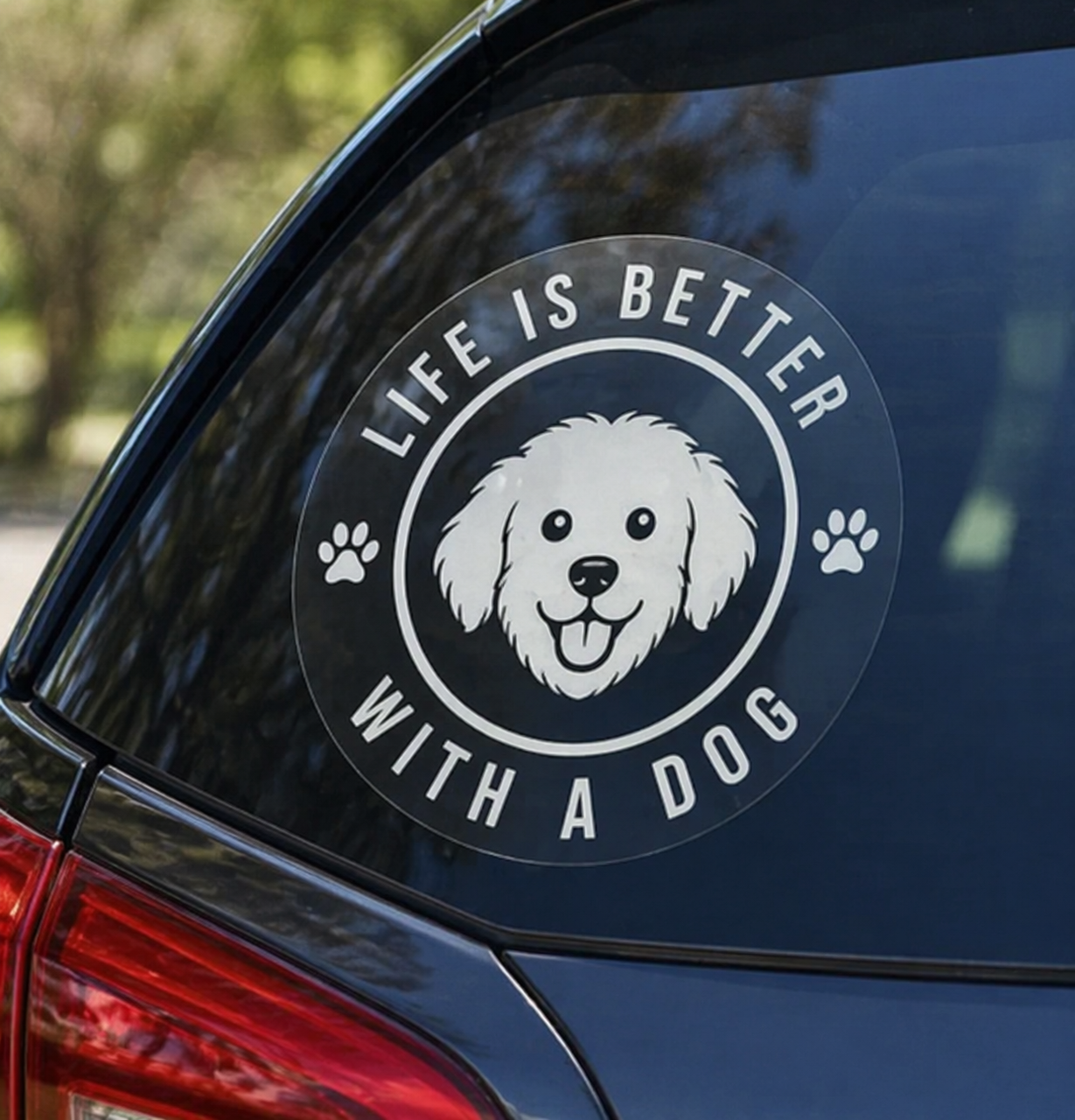 Car window with a decal that reads 'Life is better with a dog' featuring a dog's face.