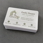 A neat thick stack of premium rectangle matte vinyl business card stickers with rounded corners, cleanly displayed on a dark grey textured studio surface.