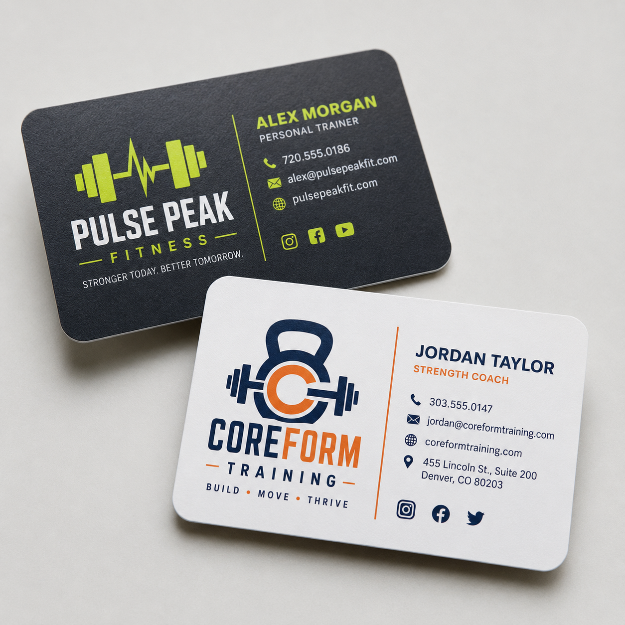 Two matte vinyl fitness business card stickers with rounded corners, one black and one white, neatly displayed side-by-side on a clean, neutral textured surface with natural lighting.