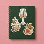 Food and drink illustration stickers displayed on a green notebook