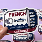 Hand holding a die-cut vinyl sticker featuring a vintage-style French sardines tin design, minimalist illustration on a soft purple background.