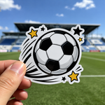 Game-day soccer ball sticker held in front of a sports field